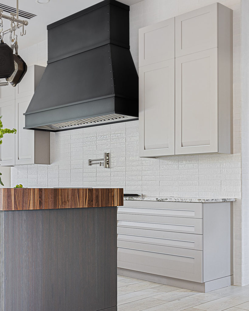 Light gray kitchen with black hood