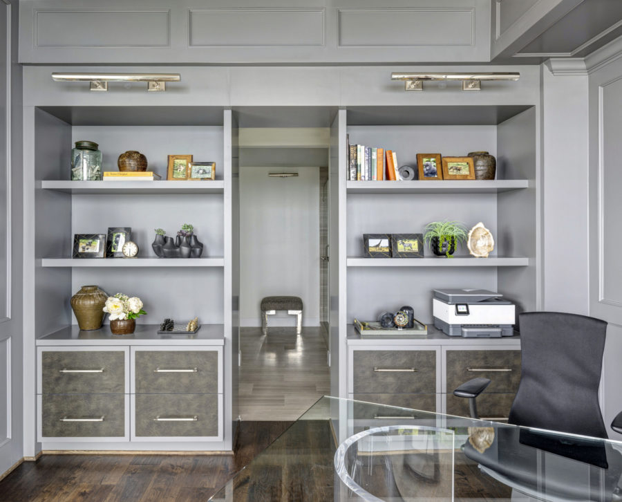 A study featuring Integra cabinetry and grey shelving