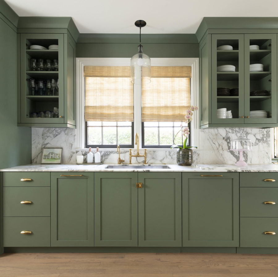 Green color painted custom cabinetry in kitchen